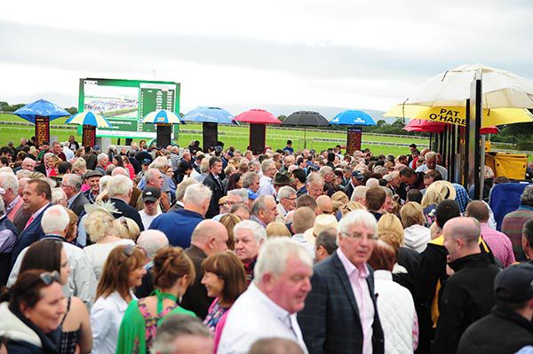 Punters queue for refunds from bets placed for the fourth race with bookmakers