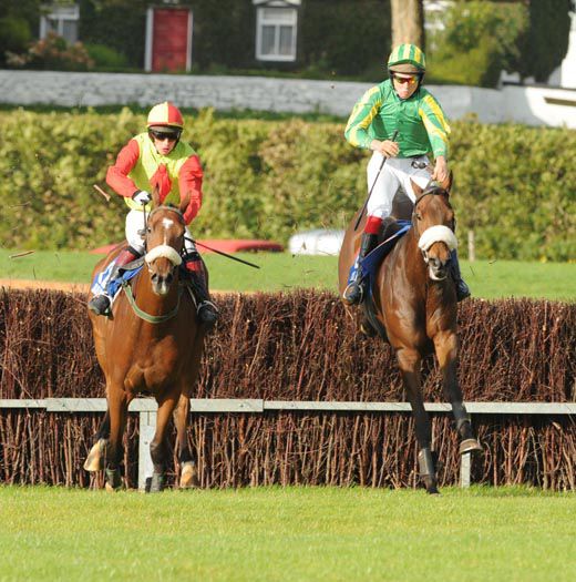 Eventual winner Port La Chaine (right) jumps the final fence alongside Jewel Of The West