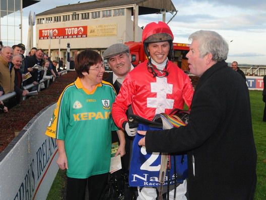 Oliver Brady plays to the Naas crowd with jockey Ross O'Sullivan and owners Pat and Anne Kangley 