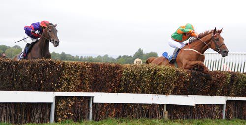 Tajweed (right) and Mark Bolger jump the final fence at Tipperary