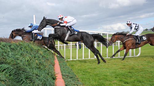 Pistol Jack (centre) jumps the last under Bryan Cooper