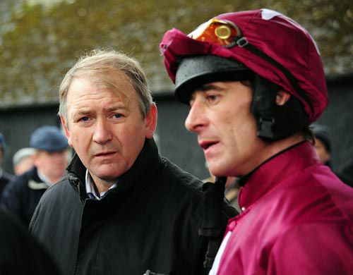 Davy Russell talks to Charles Byrnes after the victory of Sea Of Thunder