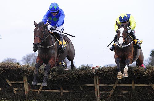 Hurricane Fly, left, jumps the last as Our Conor tries to close the gap 
