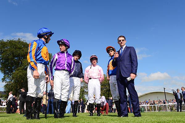 Trainer Aidan O'Brien with his five jockeys before the Irish Derby