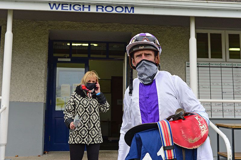 Kevin Manning after he rode his milestone 1600th winner aboard Breaking News with wife Una behind on phone