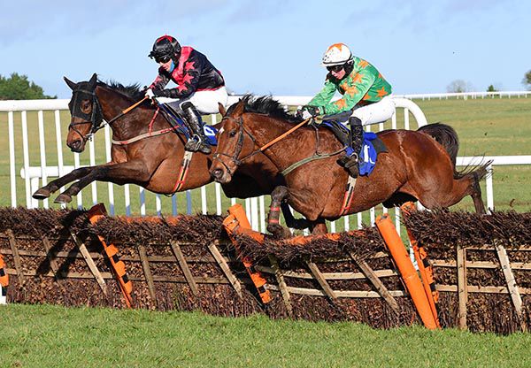 Toms Courage (left) gets the better jump at the last when battling with Danegeld 