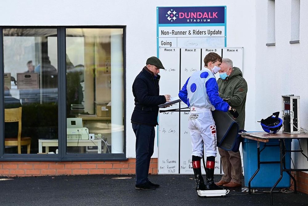 Colin Keane is weighed in by Clerk of the Scales Paul Moloney and Stewards' Secretary Tony Mulraney