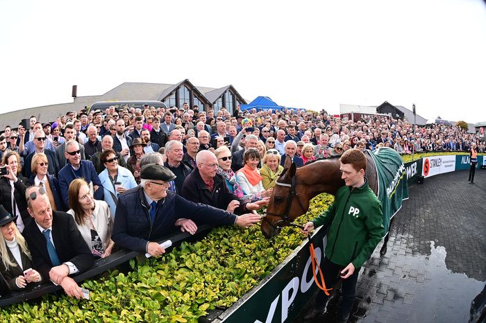 PUNCHESTOWN 29 April 2022 Paddy Power Champion Hurdle HONEYSUCKLE after winning with groom Colman Comerford and racegoers packed around the winners en