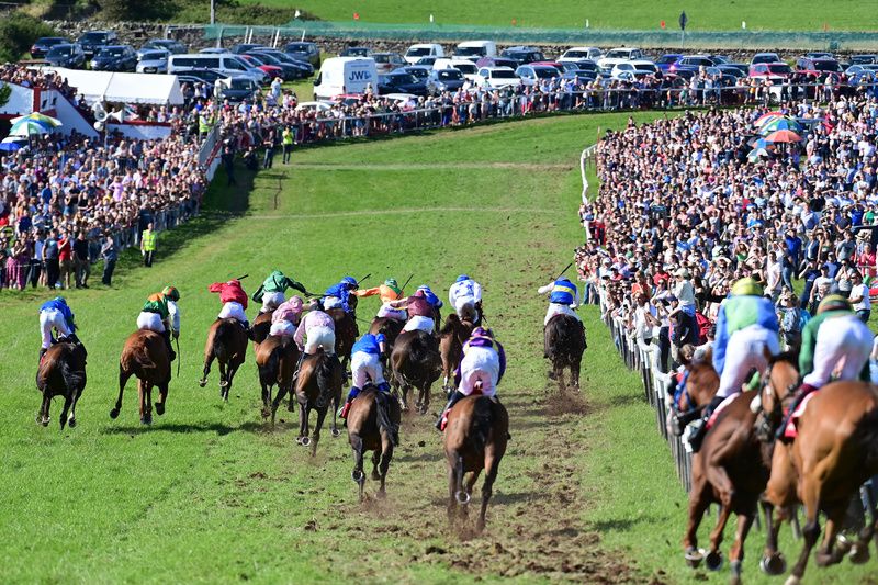 A huge crowd watches on as Paddy Hanlon (4th from left) lands the Dingle Derby