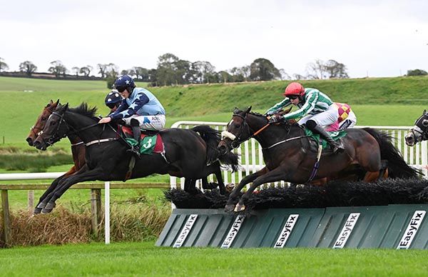 Bukhill and Eamon FItzgerald (red cap) jump the last