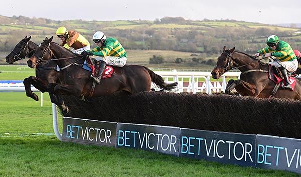 Fact To File (white cap) heads Galopin Des Champs at the last with eventual runner-up Spillane's Tower (right) 